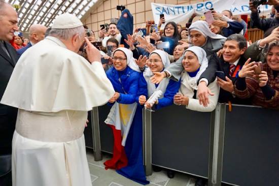 Pope Francis greeting a crowd. The Pope has the highest authority in the Catholic Church.