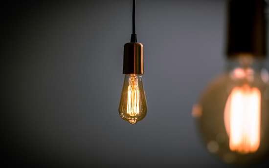 A glowing light bulb hanging from the ceiling.