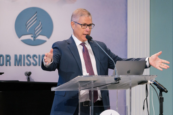 An Adventist pastor giving a sermon from a podium