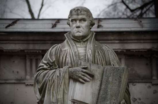 A statue of Martin Luther holding the 95 Theses