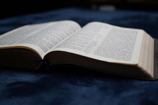 A close up of an open Bible.