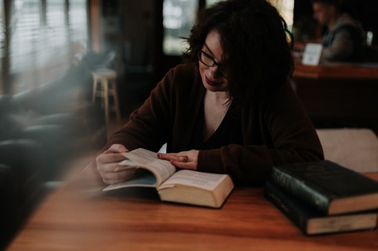 A woman studying the Bible, demonstrating how many compare a church's teachings with scripture before joining.