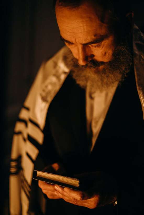 A Jewish man holding a book