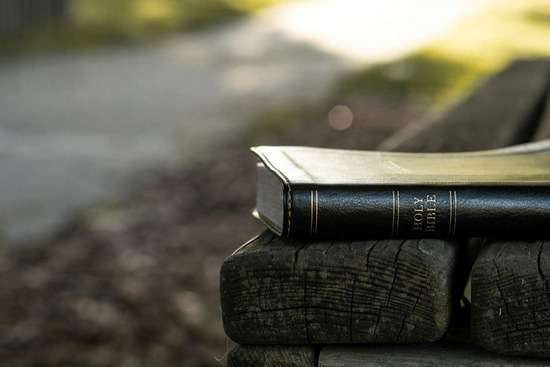 A Bible resting on a bench