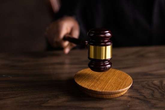 A judge hits a gavel against his desk to signify the finality of his decision.