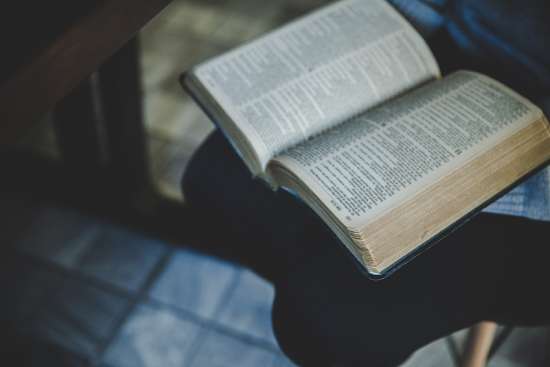 An open Bible on someone's lap