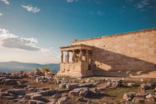 A Greek landscape with an ancient Greek structure in the foreground