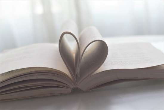 Pages of a book curled into a heart shape to represent love