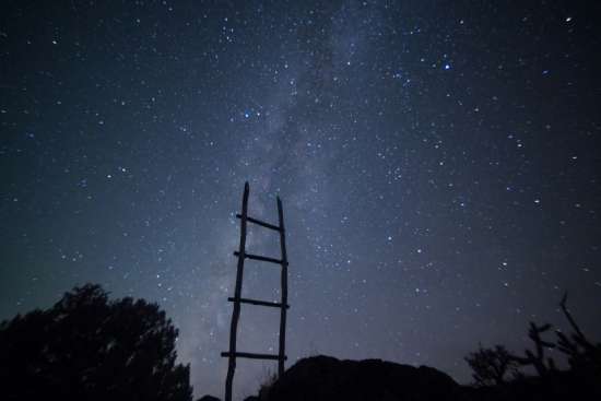 A ladder in front of a starry night sky, representing Peter's ladder of virtues