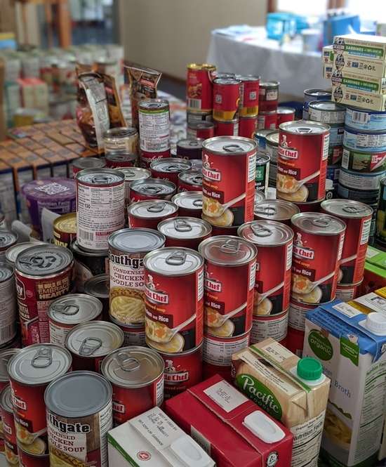 A stack of canned soup and other grocery items bought in preparation for the End Times.