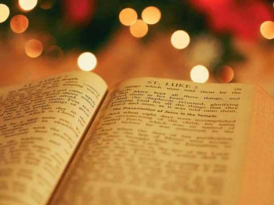 A Bible opened up the Book of Luke where it describes the birth of Jesus.