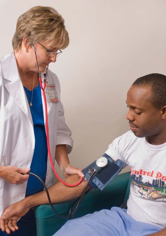 A nurse taking a man's blood pressure