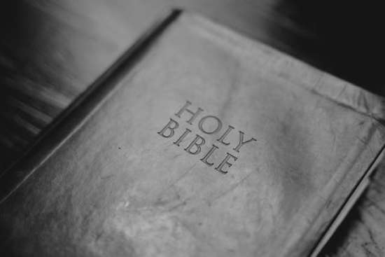 A dark-colored leather Bible