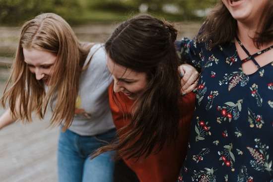 Three young women together, resembling the benefits of joining a faith community